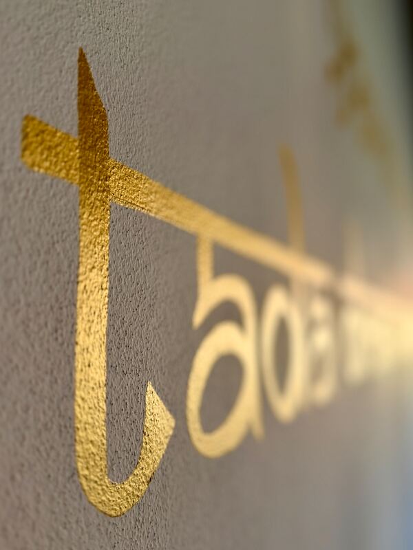 Golden lettering on the studio wall