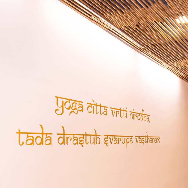 A mantra on the studio wall — yoga citta vrtti nirodha
